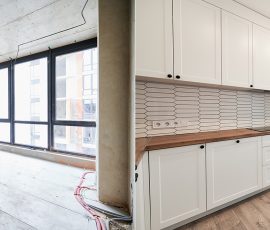 Comparison of old room before restoration and new renovated kitchen with large panoramic window, parquet floor and kitchen furniture. Photo collage of modern apartment before and after renovation.
